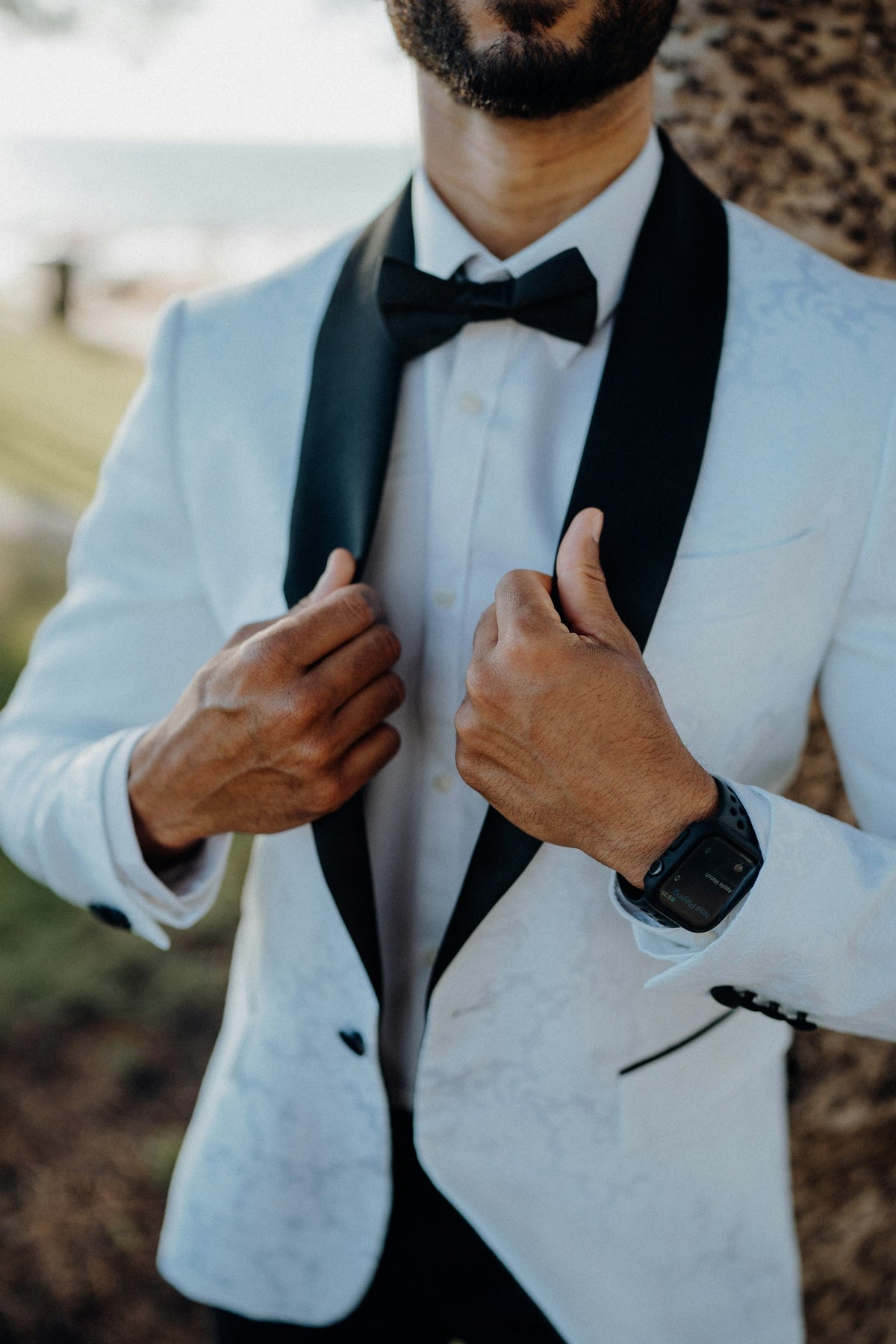 Man in a white tuxedo jacket with black lapels